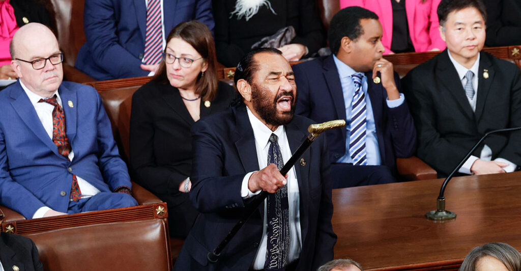 Rep. Al Green raises his cane to shout at President Donald Trump during the State of the Union.
