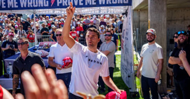 OREM, UTAH - SEPTEMBER 10: Charlie Kirk throws hats to the crowd after arriving at Utah Valley University on Sept. 10, 2025 in Orem, Utah.