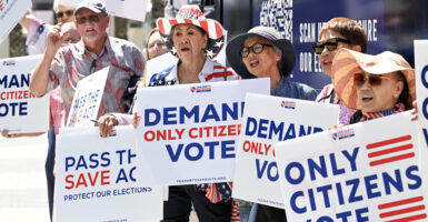 Imelda Preciado, of Garden Grove, center, joins other supporters of the SAVE Act as Tea Party Patriots Action launches a nationwide, three-week bus tour to rally support for the voting bill in Garden Grove, CA, on Monday, August 18, 2025.