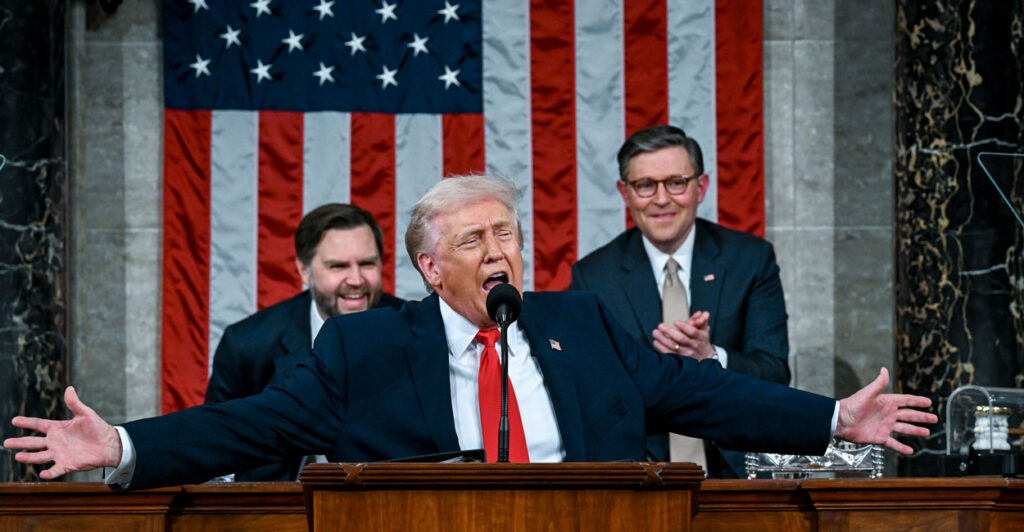 President Donald Trump gestures with his arms wide open at the State of the Union address.