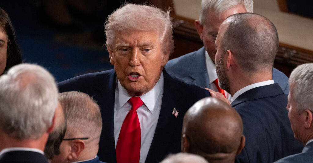President Donald Trump greets congressmen at the State of the Union Address.