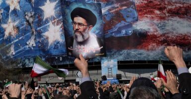 An Iranian man holds up a portrait of Iran's Supreme Leader Ayatollah Ali Khamenei during a rally in Tehran, Iran, on March 1, 2026.