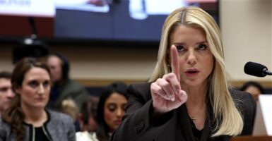 U.S. Attorney General Pam Bondi holding up one finger