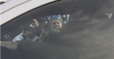 Protestors shout towards ICE Agents during a protest against U.S. Immigration and Customs Enforcement (ICE), after a U.S. immigration agent shot and killed a 37-year-old woman in her car in Minneapolis, Minneapolis, MN, U.S., January 11, 2026.