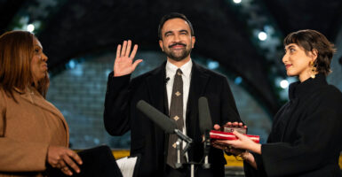 NEW YORK, NEW YORK - JANUARY 1: Zohran Mamdani is sworn in as New York City's 112th mayor by New York Attorney General Letitia James, left, alongside his wife Rama Duwaji, right, in the former City Hall subway station on January 1, 2026 in New York City. Mamdani’s term as mayor begins immediately in the new year, and a public inauguration will also take place in the afternoon at City Hall. (Photo by Amir Hamja-Pool/Getty Images)