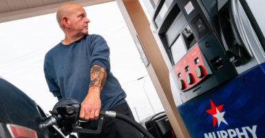 LOCKHART, TEXAS - MARCH 09: A person pumps gas at a Murphy's USA gas station on March 09, 2026 in Lockhart, Texas. A barrel of oil passed the $100 mark for the first time in four years when Russia invaded Ukraine. Diesel prices have also risen 22% to over $4.59 per gallon. (Photo by Brandon Bell/Getty Images)