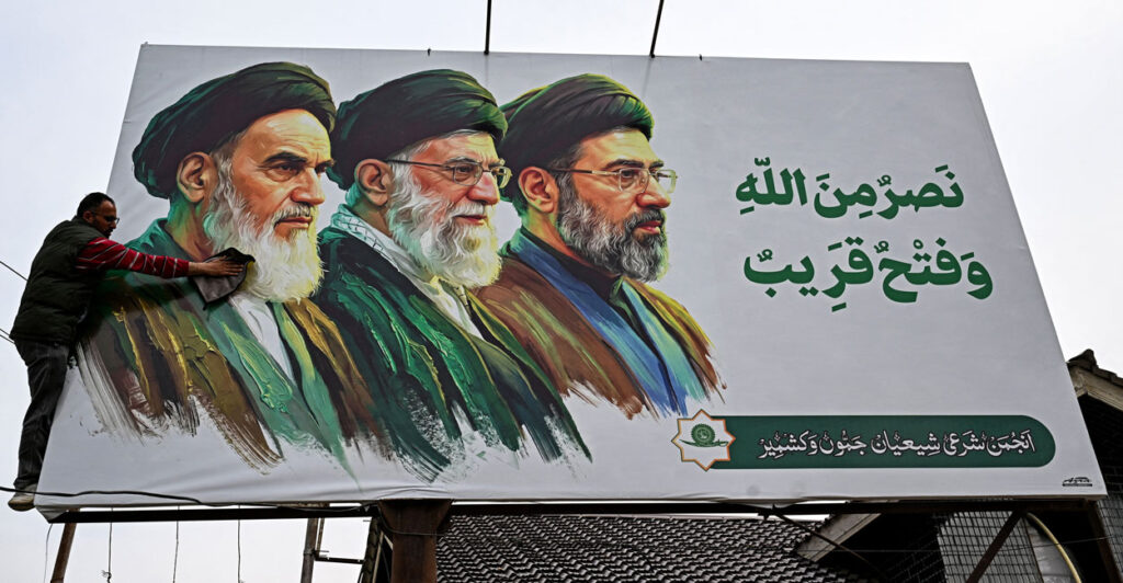 A billboard featuring portraits of Ayatollah Ali Khomeini, Ayatollah Khamenei and Ayatollah Mojtaba Khamenei