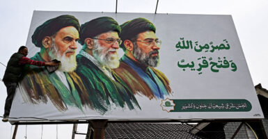 A billboard featuring portraits of Ayatollah Ali Khomeini, Ayatollah Khamenei and Ayatollah Mojtaba Khamenei