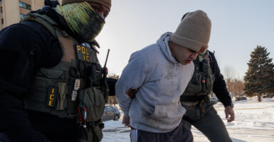 MINNESOTA, US - JANUARY 27: US Immigration and Customs Enforcement (ICE) agents detain a young man while conducting federal enforcement operations in St. Paul, Minnesota, United States on January 27, 2026. (Photo by Madison Thorn/Anadolu via Getty Images)