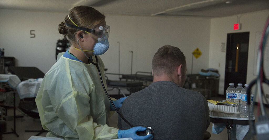 NAVAL BASE GUAM (April 14, 2020) Lt. j.g. Caroline Kivisto, a nurse assigned to 3rd Medical Battalion, 3rd Marine Logistics Group, conducts a 48-hour observation on a Sailor assigned to the aircraft carrier USS Theodore Roosevelt (CVN 71). *** NEWS EDITORIAL USE ONLY. NO COMMERCIAL USE. (including any use in merchandising, advertising or any other non-editorial use) - PAS D'UTILISATION COMMERCIALE *** (Photo by US NAVY/API/Gamma-Rapho via Getty Images)