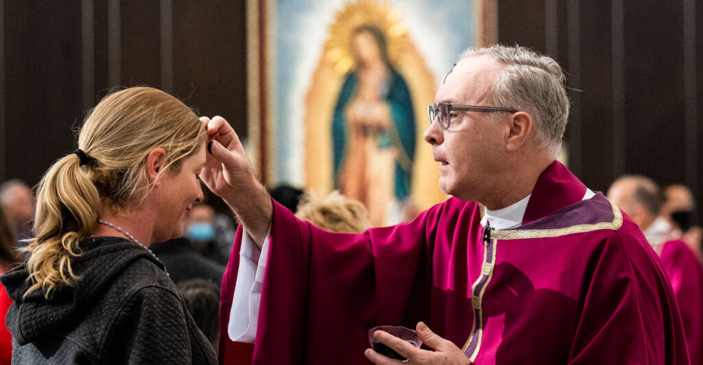 Garden Grove, CA - March 02: A woman receives ashes from Bishop Timothy Freyer during an Ash Wednesday Mass at Christ Cathedral in Garden Grove, CA on Wednesday, March 2, 2022. Ash Wednesday is the start of Lent, a time for Christians to fast and reflect leading up to Easter. (Photo by Paul Bersebach/MediaNews Group/Orange County Register via Getty Images)