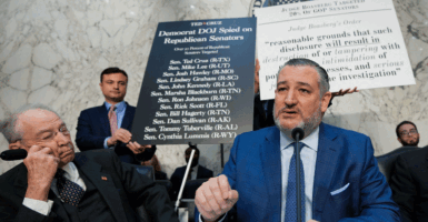 WASHINGTON, DC - MARCH 24: Subcommittee Chairman Sen. Ted Cruz (R-TX) (C) delivers an opening statement alongside posters titled 