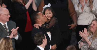 Marcus Coleman holds his daughter at the State of the Union address.