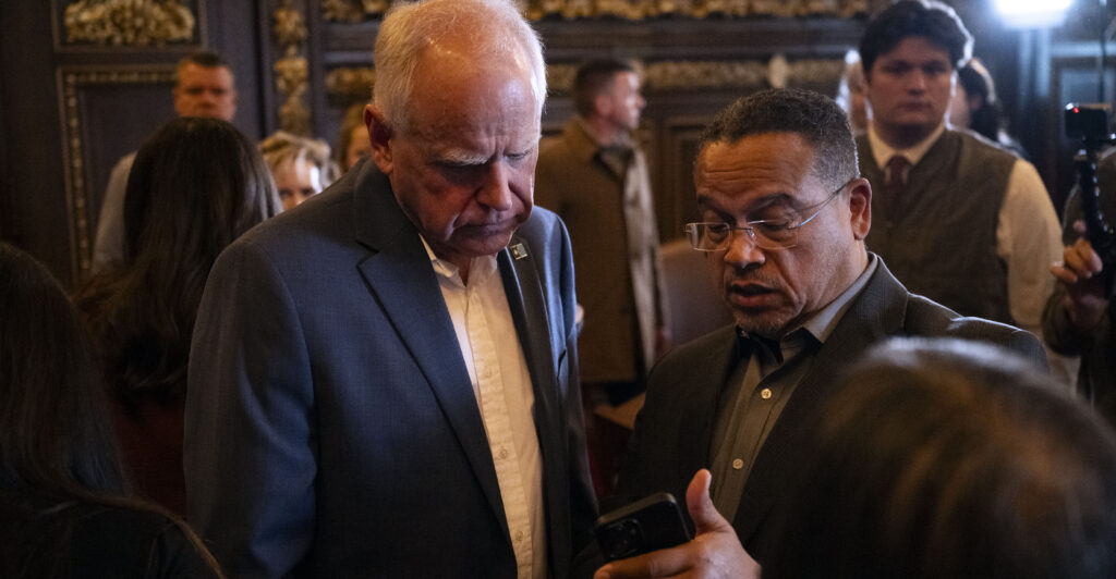 ST. PAUL, MINNESOTA - FEBRUARY 3: Minnesota Attorney General Keith Ellison (R) speaks with Minnesota Gov. Tim Walz (L) after a press conference about federal detention of children at the State Capitol building on February 3, 2026 in St. Paul, Minnesota. Trump administration officials intend to appeal a judges decision to release 5-year-old Liam Conejo Ramos who returned to Minnesota over the weekend after being held in a Texas immigration detention facility. (Photo by Stephen Maturen/Getty Images)