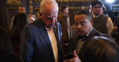 ST. PAUL, MINNESOTA - FEBRUARY 3: Minnesota Attorney General Keith Ellison (R) speaks with Minnesota Gov. Tim Walz (L) after a press conference about federal detention of children at the State Capitol building on February 3, 2026 in St. Paul, Minnesota. Trump administration officials intend to appeal a judges decision to release 5-year-old Liam Conejo Ramos who returned to Minnesota over the weekend after being held in a Texas immigration detention facility. (Photo by Stephen Maturen/Getty Images)