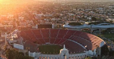 In an aerial view, the Los Angeles Memorial Coliseum and Lucas Museum of Narrative Art (R) in Exposition Park is shown on March 5, 2026 in Los Angeles, California. The stadium will host the 2026 FIFA World Cup and the 2027 LA Olympics.