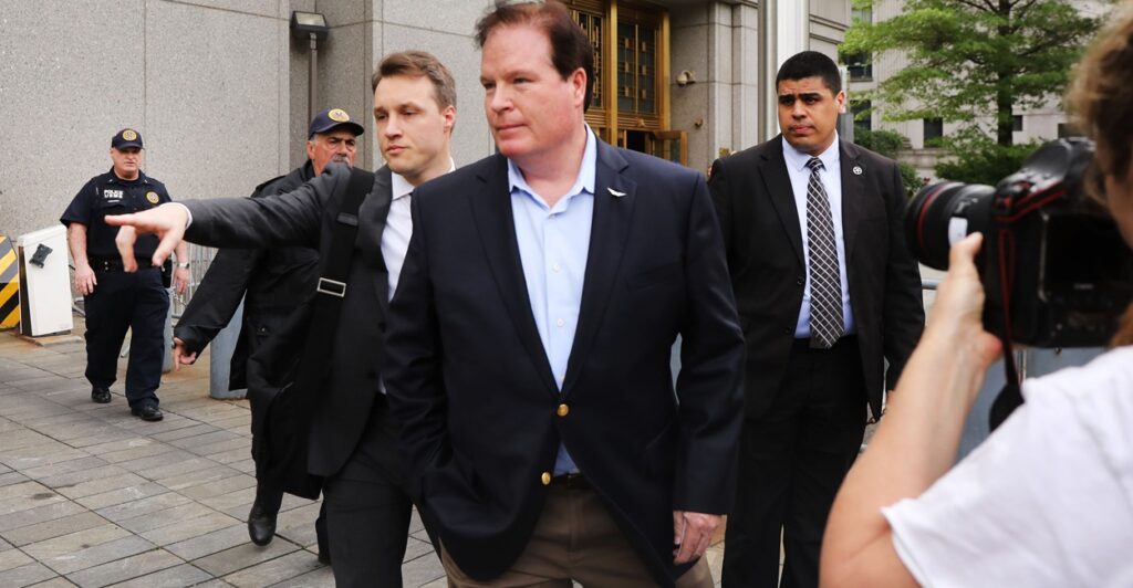 Several men in suits standing outside