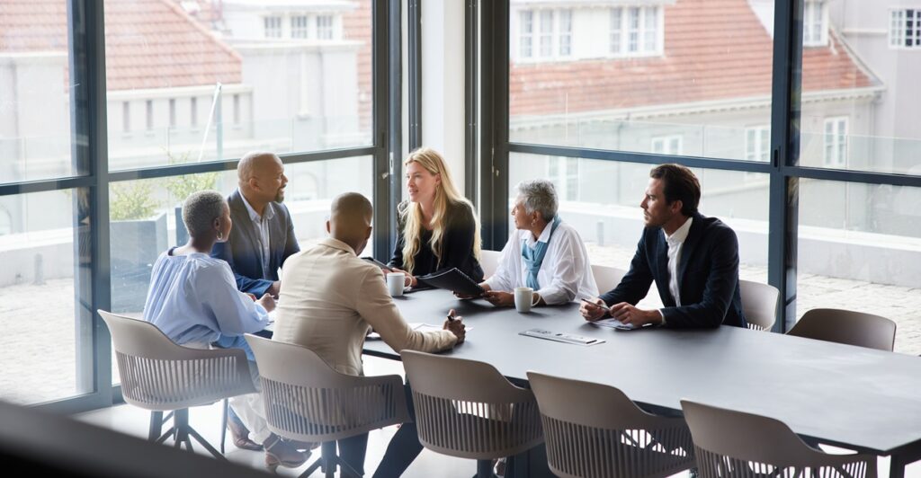 A group of people around a conference table.