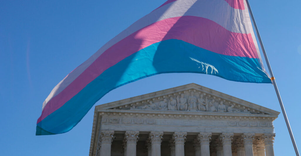 Trans flag waving in front of Supreme Court.