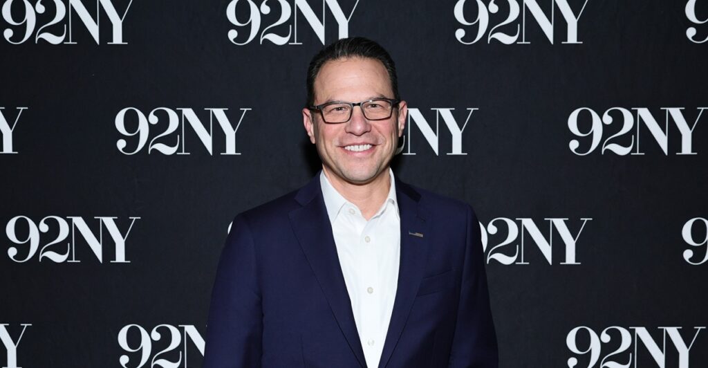 Josh Shapiro standing in front of a wall that says "92NY"