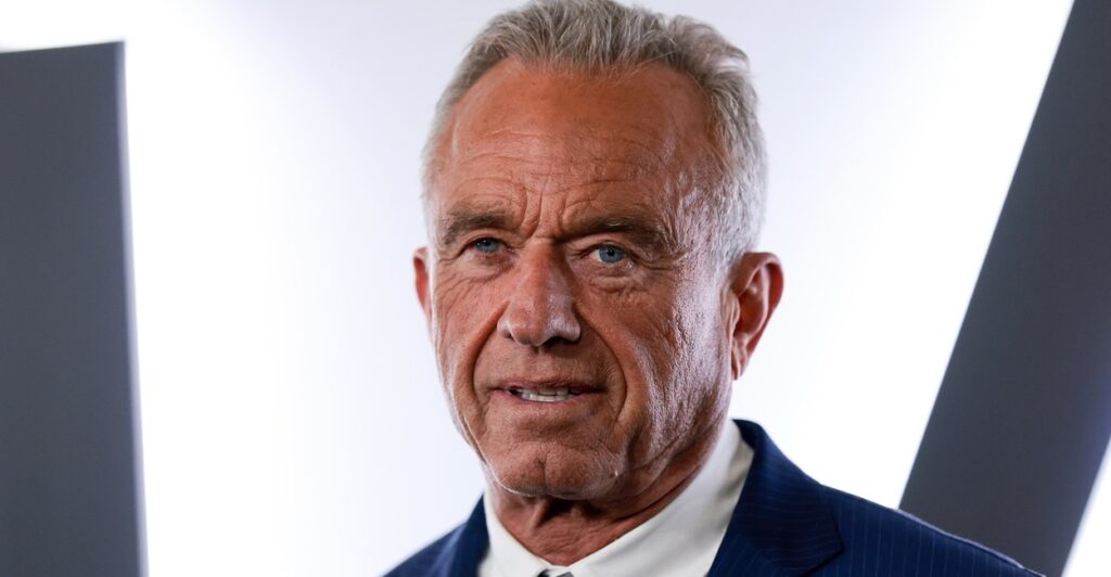 Robert F. Kennedy Jr. in front of a white and black wall.