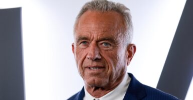 Robert F. Kennedy Jr. in front of a white and black wall.