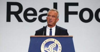 Robert F. Kennedy Jr. speaking at a podium.