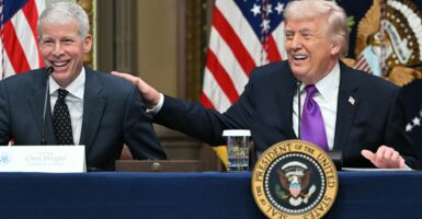 Chris Wright and Donald Trump laughing while sitting at a table.
