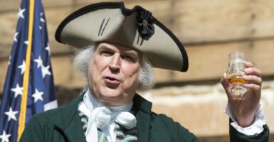 Geroge Washington reenactor holding up a glass.