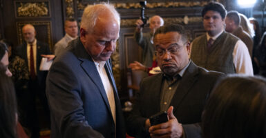 ST. PAUL, MINNESOTA - FEBRUARY 3: Minnesota Attorney General Keith Ellison (R) speaks with Minnesota Gov. Tim Walz (L) after a press conference about federal detention of children at the State Capitol building on February 3, 2026 in St. Paul, Minnesota. Trump administration officials intend to appeal a judges decision to release 5-year-old Liam Conejo Ramos who returned to Minnesota over the weekend after being held in a Texas immigration detention facility. (Photo by Stephen Maturen/Getty Images)