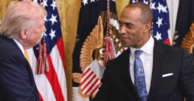 (L/R) US President Donald Trump shakes hands with Secretary of Housing and Urban Development (HUD) Scott Turner during a Black History Month event in the East Room of the White House in Washington, DC, on February 18, 2026. (Photo by SAUL LOEB / AFP via Getty Images)
