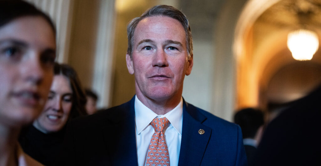 Sen. Jon Husted looks on as he's surrounded by reporters on Capitol Hill.