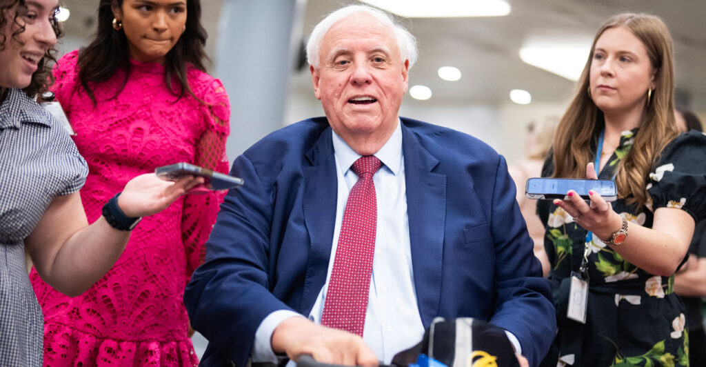 Senator Jim Justice speaks to reporters in the Capitol.