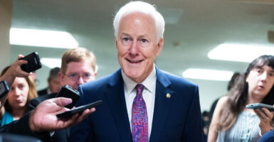 John Cornyn speaks to reporters in the hallway of the capitol.