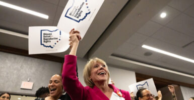 Two women hold signs reading "Ohioans United for Reproductive Freedom."