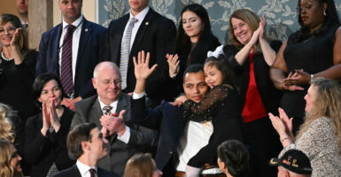 7-year-old Dalilah Coleman, held by her father Marcus Coleman as they are recognized by US President Donald Trump as he delivers the State of the Union address in the US Capitol in Washington, DC, on February 24, 2026.