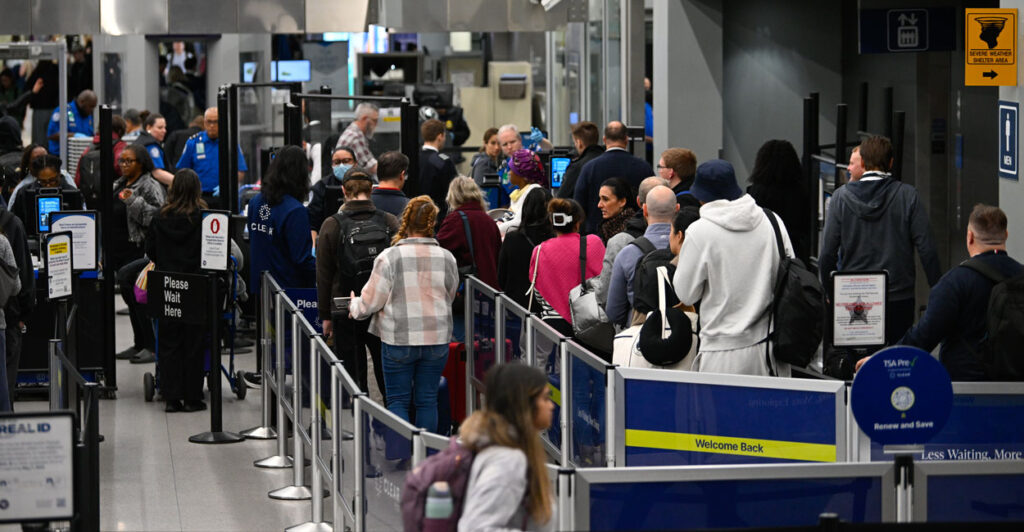 People wait in long TSA lines as the partial government shutdown continues for several weeks at airports like Chicago.