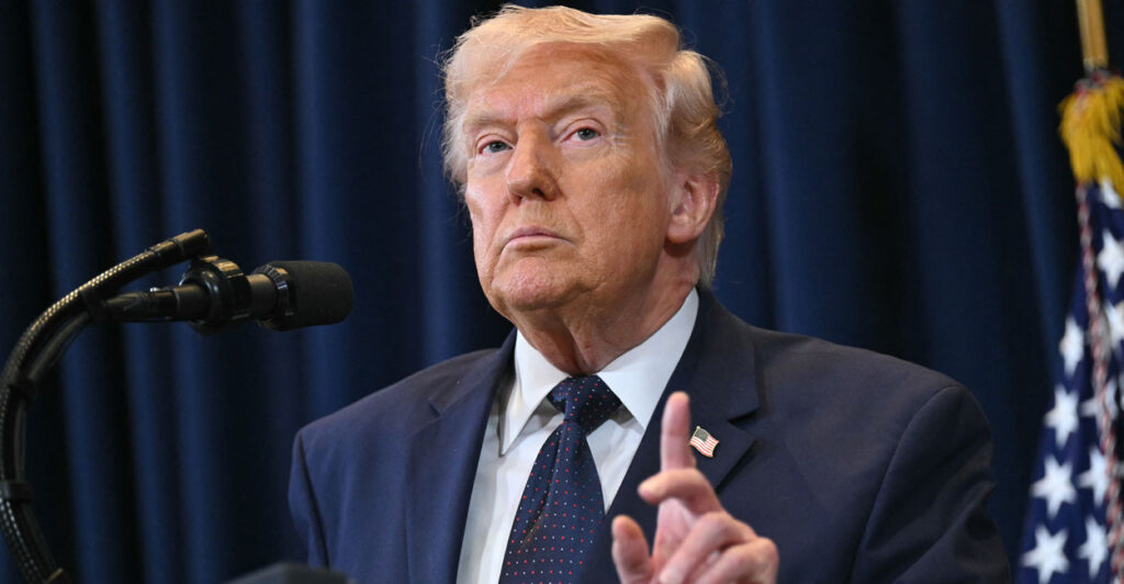 President Donald Trump gestures at the podium.