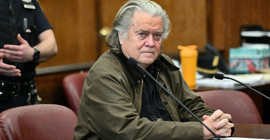 Steve Bannon sitting in a courtroom looking at the camera.