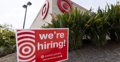 A red-and-white "We're Hiring" sign outside a Target store.