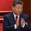 Xi Jinping applauding.