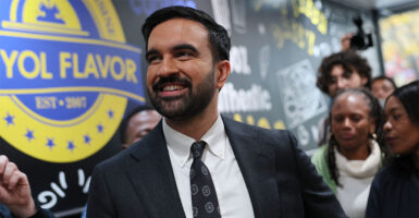 NEW YORK, NEW YORK - OCTOBER 25: Democratic Mayoral Candidate Zohran Mamdani looks at the menu inside of Kreyol Flavor as he takes a tour of the neighborhood on October 25, 2025 in the East Flatbush neighborhood of the Brooklyn borough in New York City.