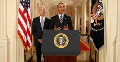 Then-President Barack Obama speaks to the nation from behind a podium, with Vice President Joe Biden behind him.