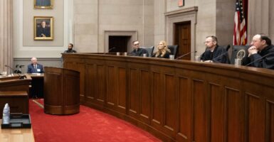 Justices sit and listen during a ceremony at the Virginia Supreme Court