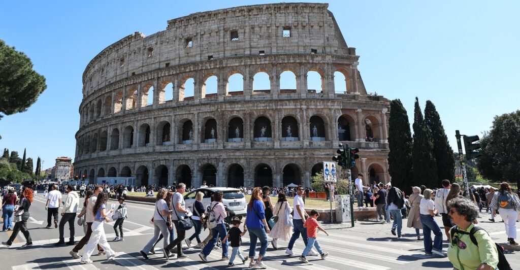 People walking past the Colosseum