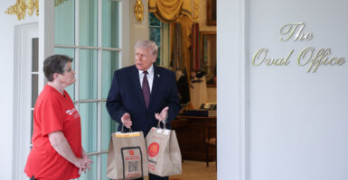 President Donald Trump receives a DoorDash delivery of McDonald's outside the Oval Office of the White House on April 13, 2026.