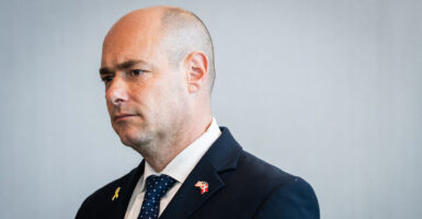 Rep. Greg Landsman stands looking to the side.