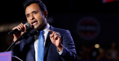 Vivek Ramaswamy gestures while up at a podium.