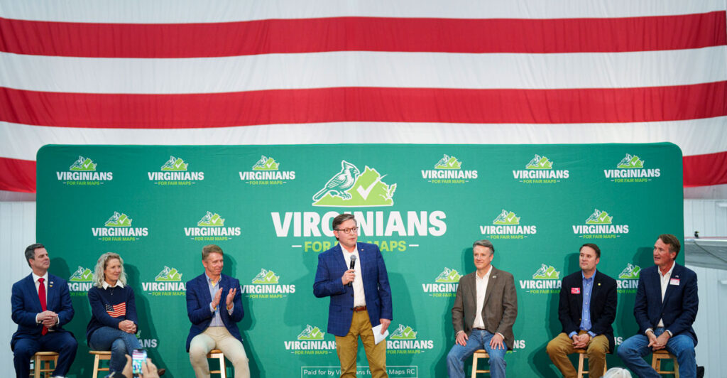 Speaker of the House Mike Johnson, R-La., speaks at the Virginians for Fair Maps rally in Bridgewater, Va., on Saturday, April 11, 2026. Also on stage from left are Rep. John McGuire, R-Va., Rep. Jen Kiggans, R-Va., Rep. Rob Wittman, R-Va., Rep. Ben Cline, R-Va., former Virginia Attorney General Jason Miyares, and former Virginia Governor Glenn Youngkin.